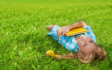 Image showing student laughing with book smiling