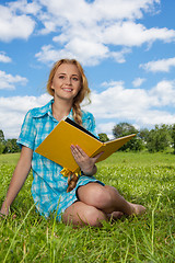 Image showing smiling girl sitting with book