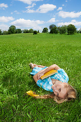 Image showing smiling girl laying on lawn