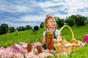 Image showing Little girl drinking on picnic