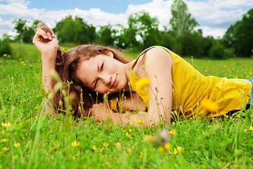 Image showing pretty girl resting on grass