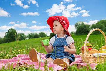 Image showing cute girl in ted hat drinking