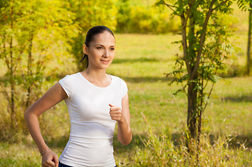 Image showing girl running in white t-shirt