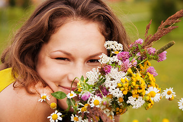 Image showing pretty girl smiling with bouquet