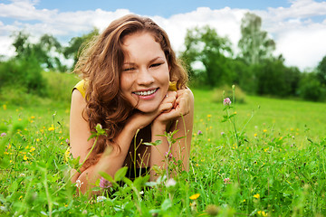 Image showing nice girl laying on green grass