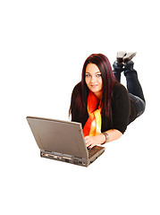 Image showing Girl lying on floor with laptop.