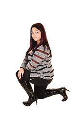 Image showing Girl in boots kneeling.