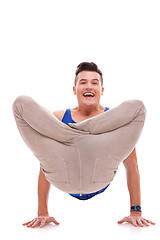 Image showing smiling young man standing on his hands