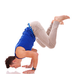 Image showing barefoot casual man doing a handstand 