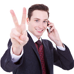 Image showing  business man making victory sign on phone