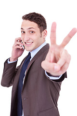 Image showing business man making victory sign on phone