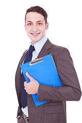 Image showing Businessman smiles with clipboard in his hand