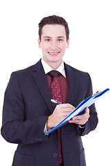 Image showing Business man writing on clipboard