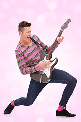 Image showing  casual young man playing a guitar