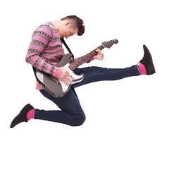 Image showing passionate guitarist jumps in the air 