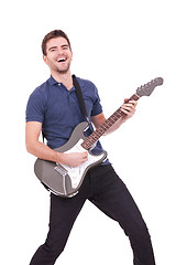 Image showing smiling man playing an electric guitar