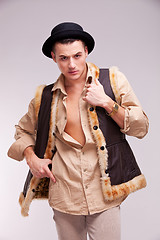 Image showing man with hat and funny fur coat posing 