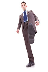 Image showing business man stepping on something