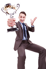 Image showing excited young business man winning a nice trophy