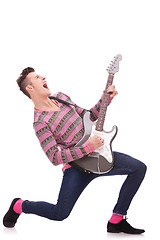 Image showing screaming young guitarist playing his guitar