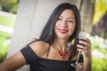 Image showing Attractive Hispanic Woman Portrait Outside Enjoying Wine