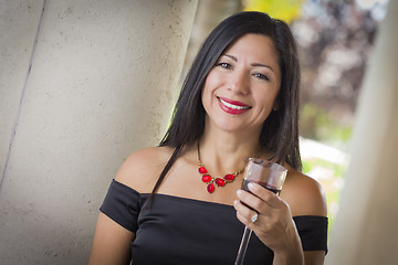 Image showing Attractive Hispanic Woman Portrait Outside Enjoying Wine