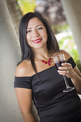 Image showing Attractive Hispanic Woman Portrait Outside Enjoying Wine