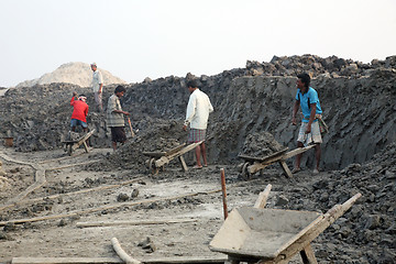 Image showing Brick field. Laborers are carrying deposited soil for making raw brick. in Sarberia, West Bengal, India.