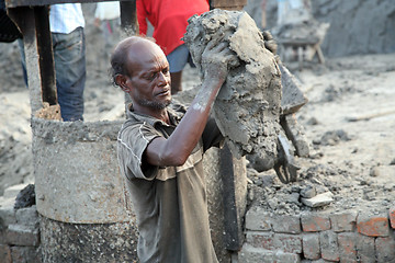 Image showing Brick field. Laborers are carrying deposited soil for making raw brick. in Sarberia, West Bengal, India.