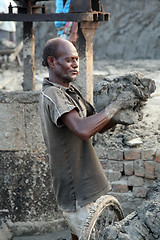 Image showing Brick field. Laborers are carrying deposited soil for making raw brick. in Sarberia, West Bengal, India.