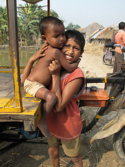 Image showing Sayan Payne holding his little brother Rajneesh at remote village in Sundarbands, West Bengal, India