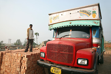 Image showing Brick field workers carrying complete finish brick from the kiln