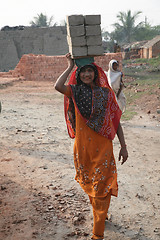 Image showing Brick field workers carrying complete finish brick from the kiln
