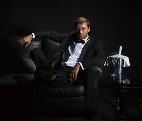 Image showing Sexy man in tuxedo waiting for his date