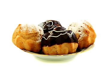 Image showing Eclairs with frosting in a plate.