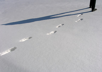 Image showing Man legs and footprints on the snow