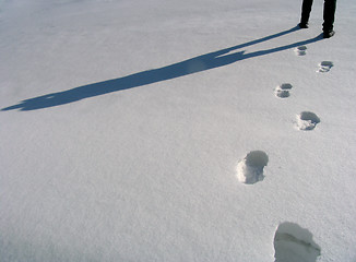 Image showing Man legs and footprints on the snow