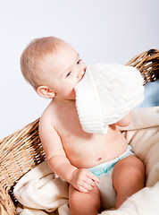 Image showing cute little baby infant in basket with teddy 