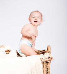 Image showing cute little baby infant in basket with teddy 