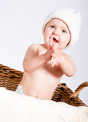 Image showing cute little baby infant in basket with teddy 