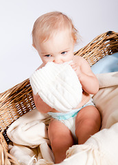 Image showing cute little baby infant in basket with teddy 