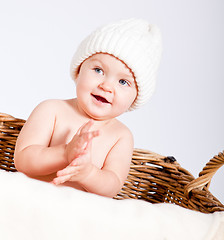 Image showing cute little baby infant in basket with teddy 