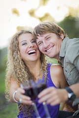 Image showing An Attractive Couple Enjoying A Glass Of Wine in the Park