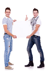 Image showing two young men holding a blank board 