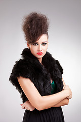 Image showing glamour woman in black dress with fur 