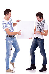 Image showing two young men holding a blank board 