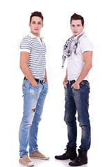 Image showing two  friends standing  with their hands in pockets