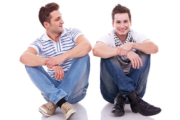 Image showing two casual men sitting on a white background