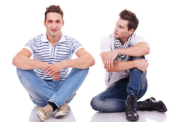 Image showing two casual men sitting on a white background