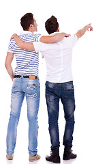 Image showing  two young men pointing at somethin